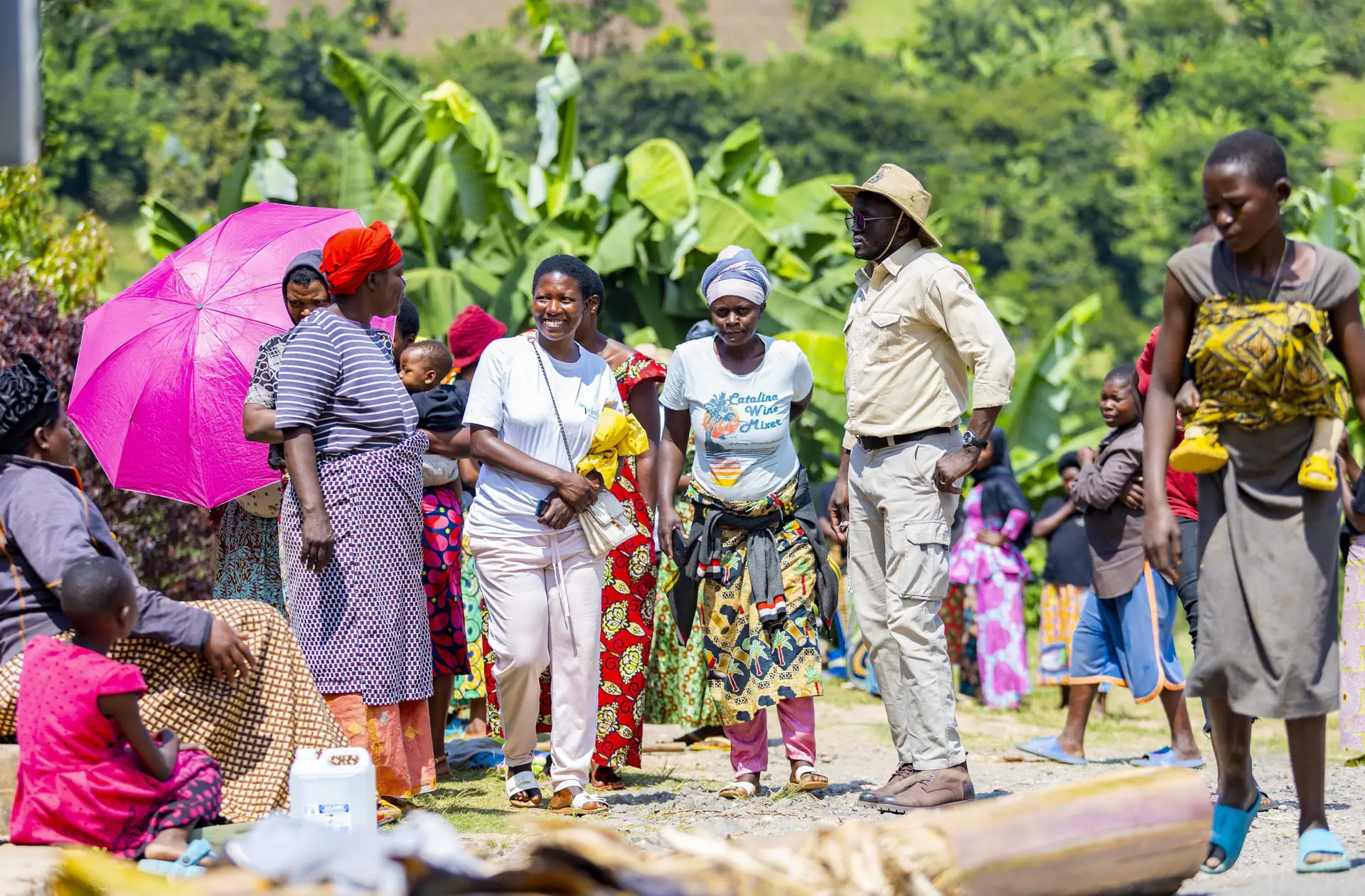 A large community gathering of women and men in rural Rwanda
