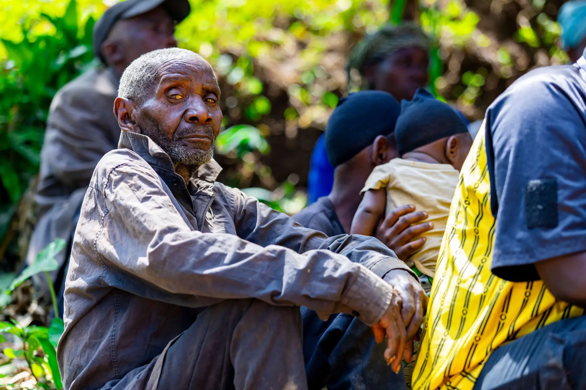 An elder listening during a community meeting