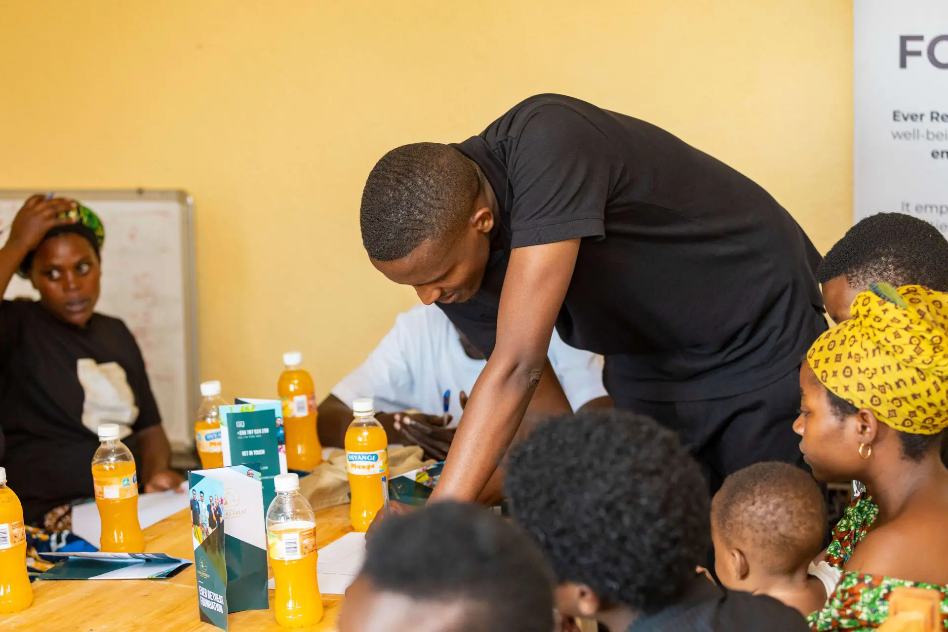 A mentor guiding participants through a hands-on training exercise