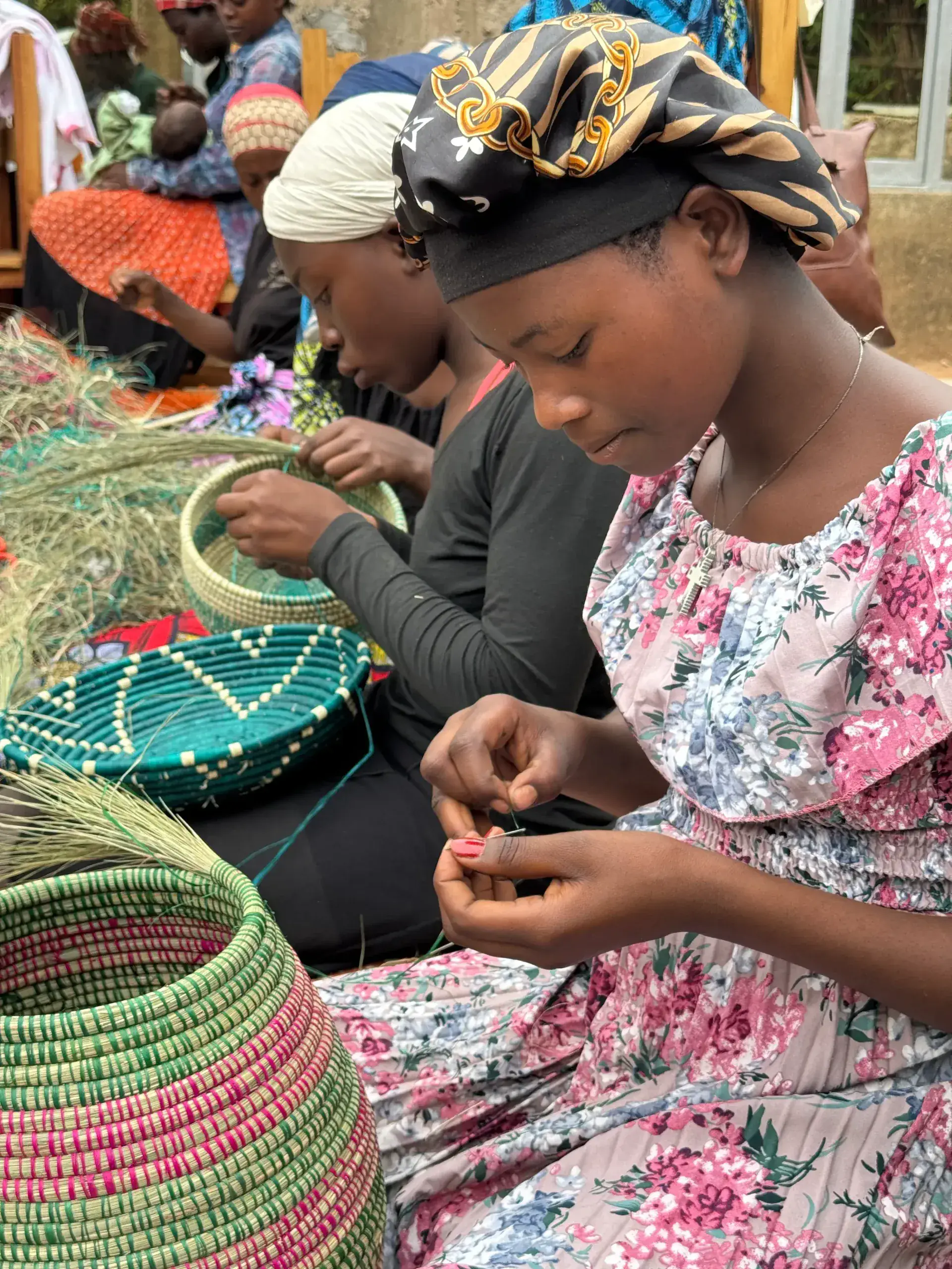 A young woman weaving a colorful basket